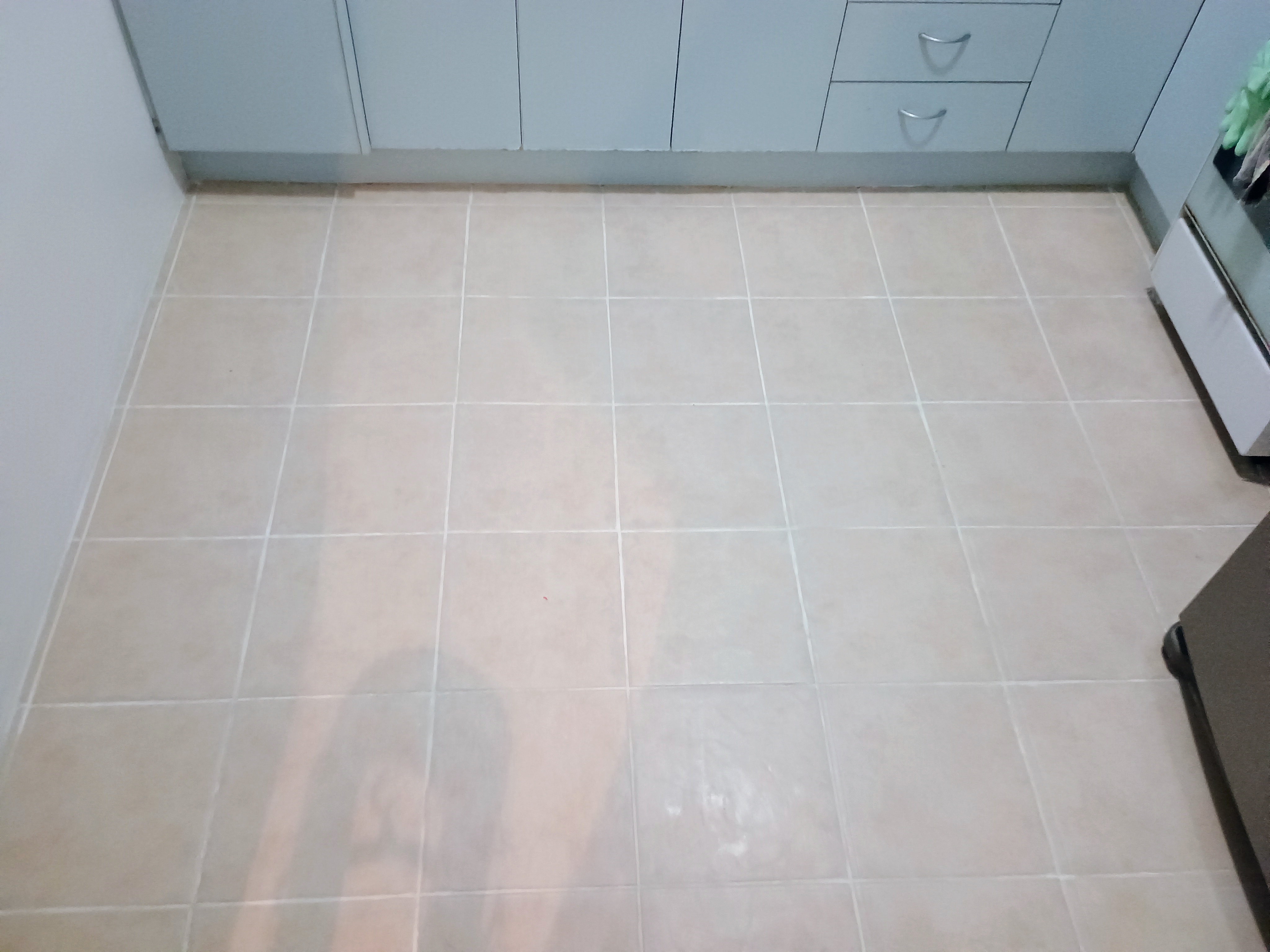 Kitchen floor after restoration, showing clean and even light grout lines